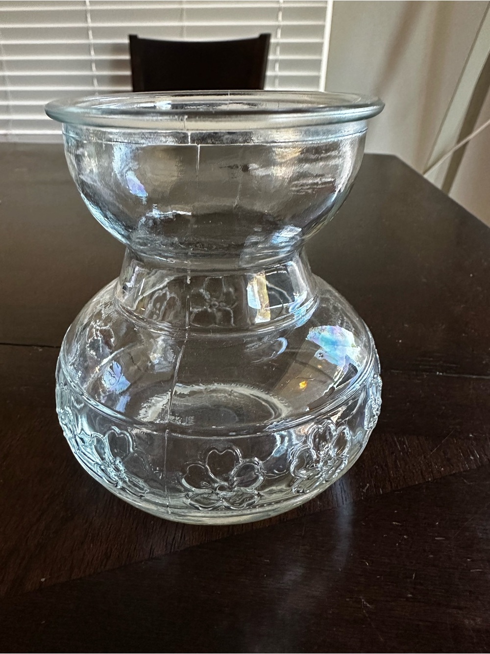 Clear glass bulb forcing vase embossed floral pattern around the base